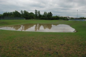 The new retention pond and football field quickly flooded during a heavy rain downpour. However, the field is designed to pool on the sidelines in cases of quick and heavy rain so that it can run off into the retention pond.