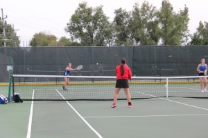 Seniors Maggie Hilton, left, and Jamie Pryhuber, right, work together against the opposing team. The two have practiced hard all season and it has paid off with an almost perfect record for the pair. 
