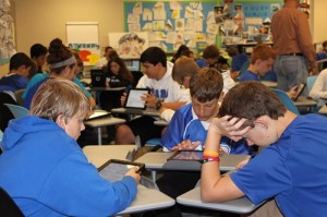 Students in World Cultures class gather in a circle to work together on an assignment. New desks and whiteboards in the classroom allow the students to be more mobile and participate more, according to Meghan Reynolds, English teacher. 