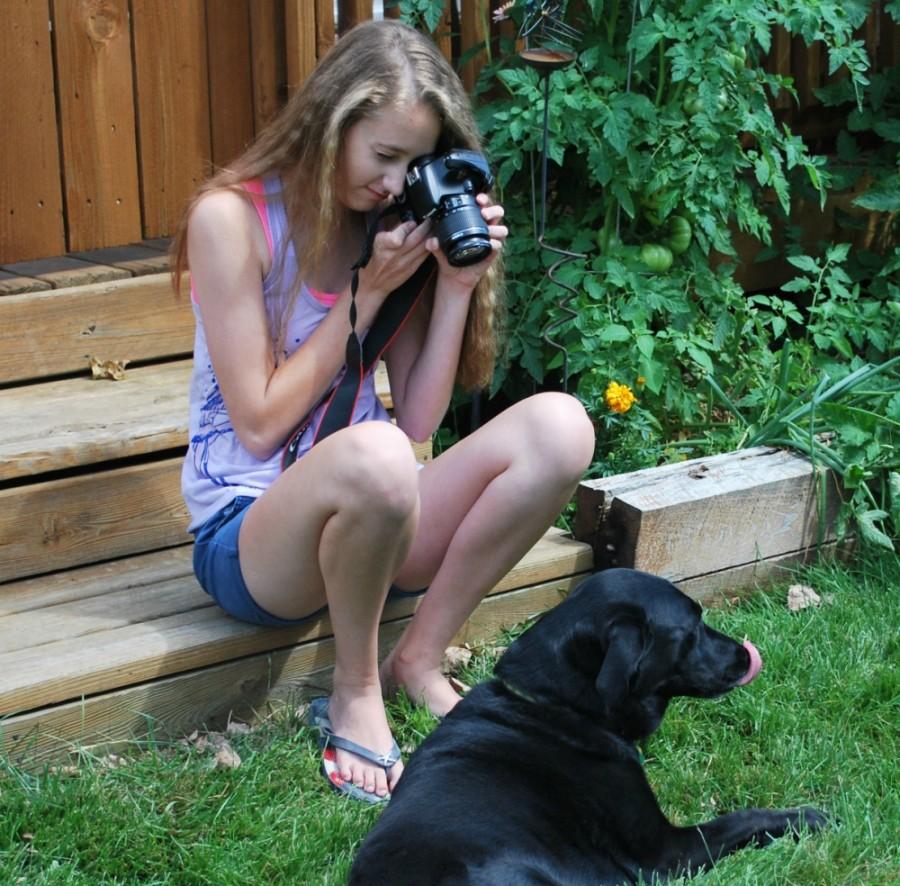 Meredith Schiferl practices taking pictures for yearbook.