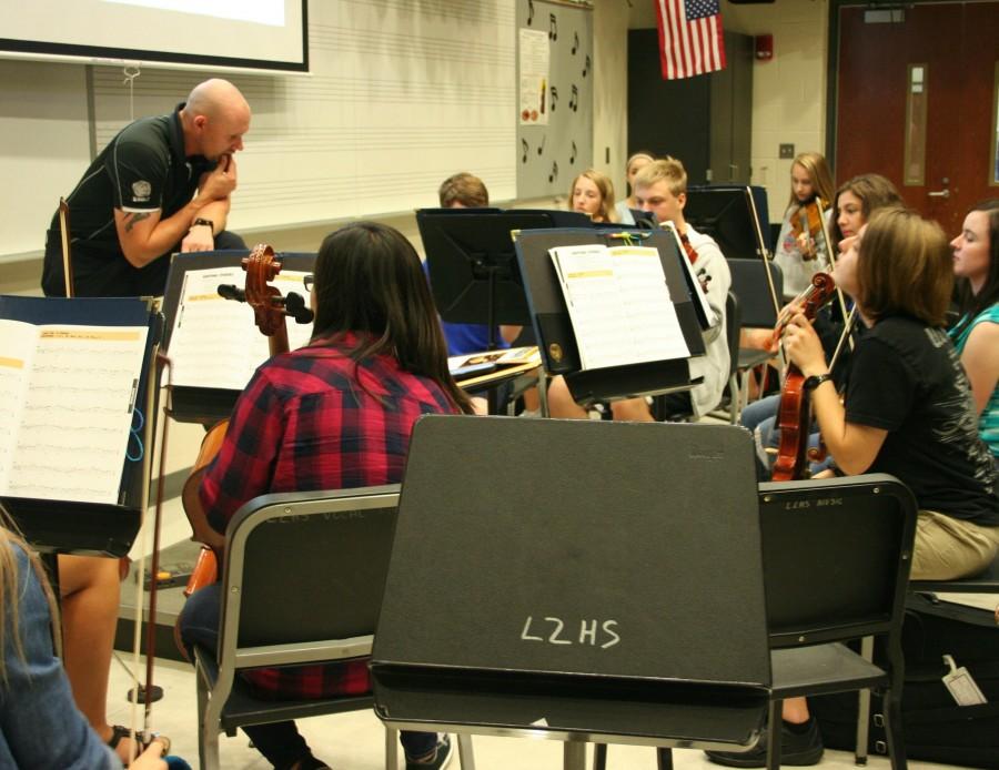 Serge Penksik, orchestra director, leads his fourth period orchestra class during rehearsal. The fourth period concert orchestra was added just this year. 