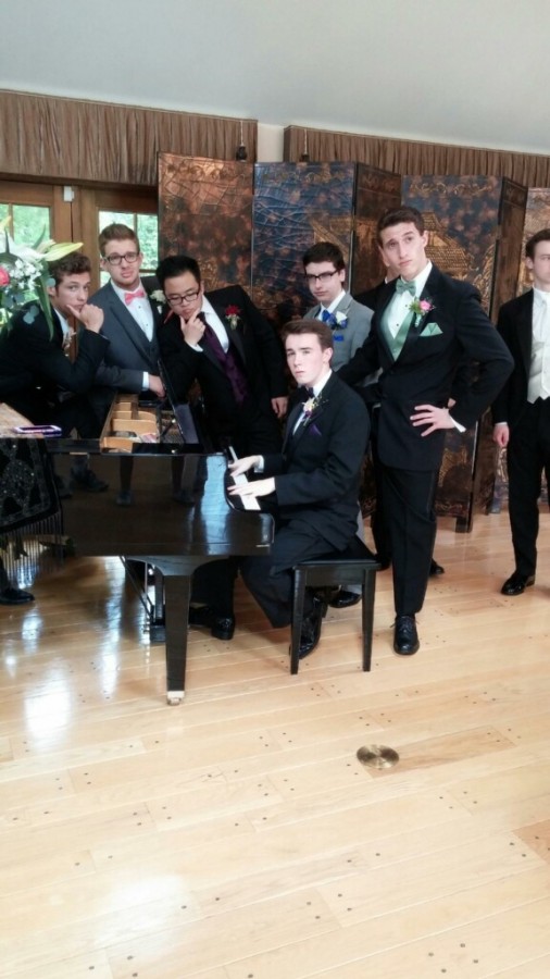 Gallagher poses on the piano [center] with Dever [right] and other friends at prom.