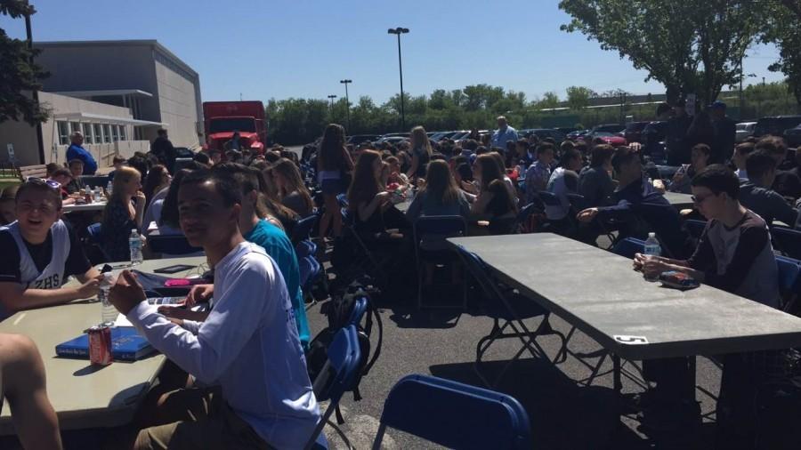 Students at last years Bears BBQ enjoy the weather and some burgers. The school holds the event twice a year to allow students to relax and change their routine. 
