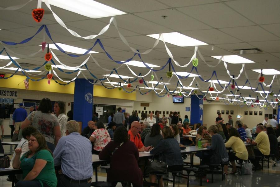 Some parents view open house, now known as curriculum night, as an insightful way to start the year with their children. Parents wait in the cafeteria before they move on to their 
students’ next class.