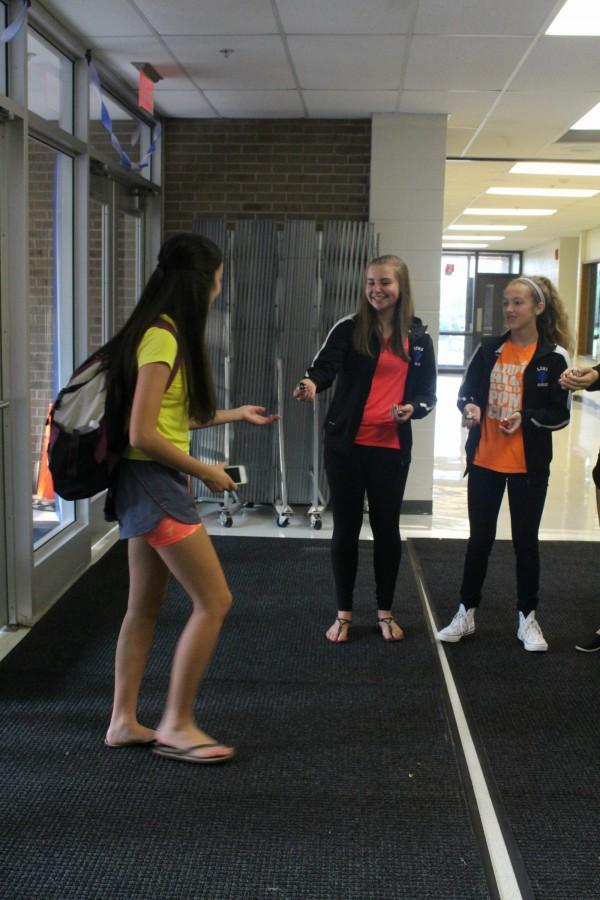 Poms greets students at the main entrance. Theyre building hype for their upcoming season.