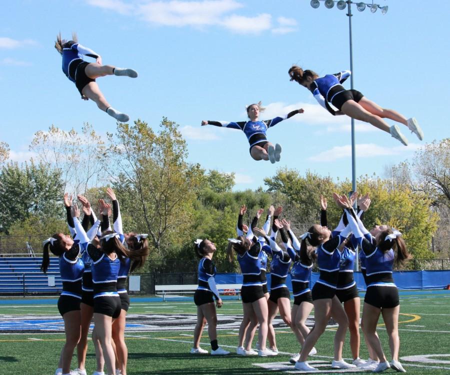 Cheerleaders celebrate LZ Nation as they fly high during the assembly. The team took home first place in Sectionals last season, and went on to finish in the top 10 at the State competition.