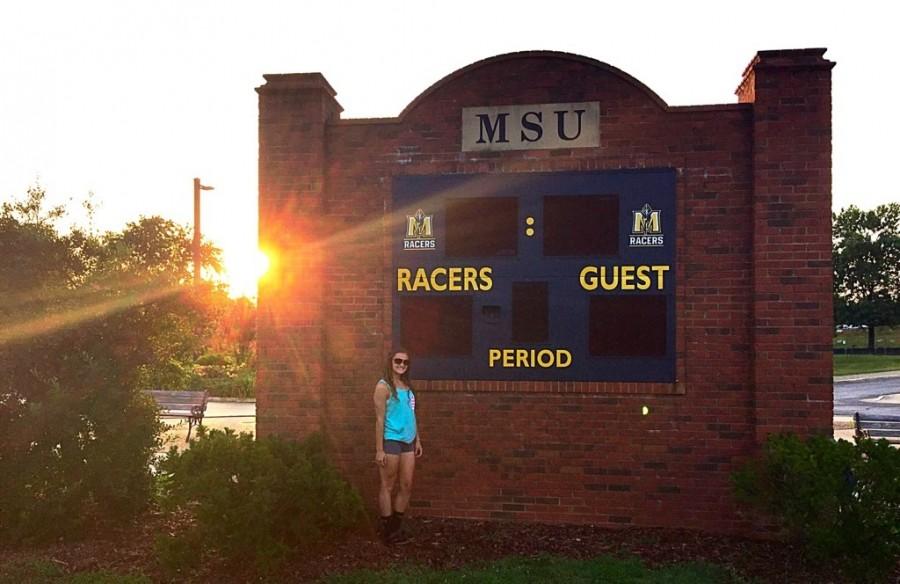 Rebecca Kubin, junior, poses next to a scoreboard at Murray State University, the college she has verbally committed to. Kubin committed early with hopes of playing Division I soccer in college. 