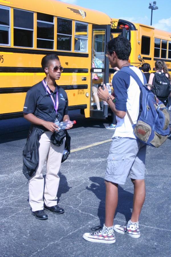 Val Redmond interacts with a student after school at bus duty. (goes to picture with Val and student by bus)