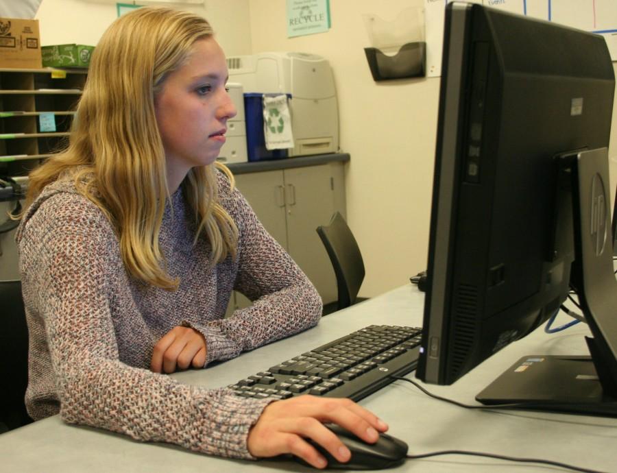 Tara Wilkes on the computer taking her Econ class to get ahead in her studies.