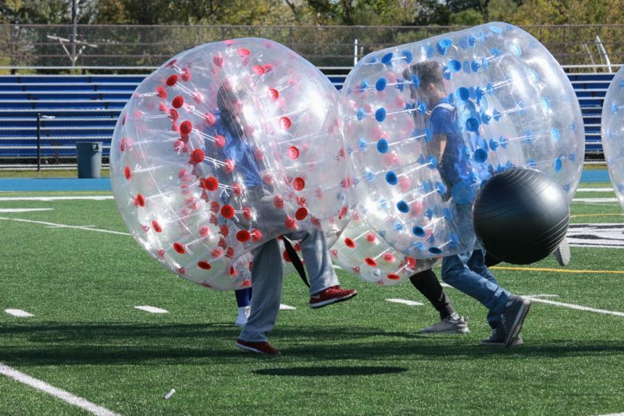 Two boys face off in a game of hamster ball soccer. The soccer games and a relay race were two of the activities made possible by the outdoor assembly.