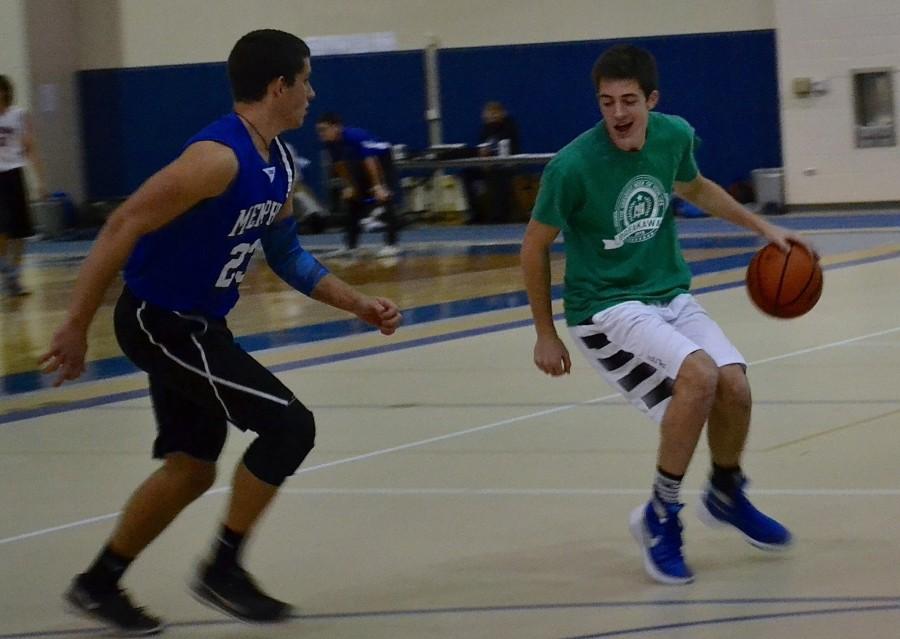 Alex Miller, junior, guards Ryan Kutsor, sophomore, during the 3 on 3 Ball Gives Life tournament on December 7. The tournament hosted 100 players and raised over $550 for the Alexander Leigh Center for Autism 
