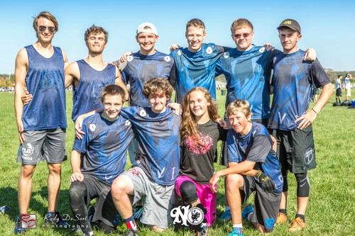 The Ultimate Frisbee team captains with their team. Theyre huddled together for a team family photo.