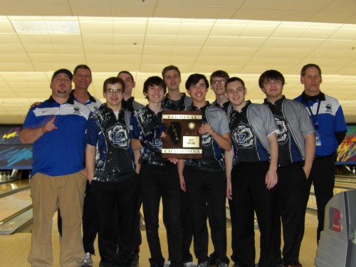 Coaches, Mike Sutton, Kirk Reusch, and Steve Schmitz gather with the boys bowling team as they pose with their first place plaque at regionals. This is the team's first time winning the IHSA regional championship.