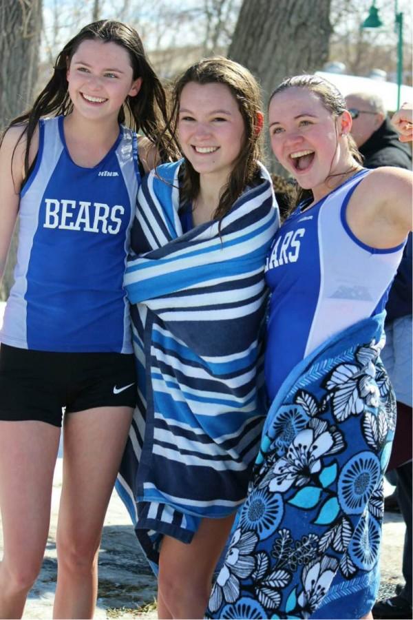 Kiersten McDevitt, Vada Murray, and Natalie Ullman, juniors, pose after running into Lake Zurich. The Girls Track and Field team has been participating in the Purple Plunge, a fundraiser that is run by the American Cancer Society, for many years. 