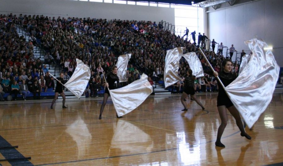 Color+Guard+performs+at+the+Spring+Assembly%2C+an+event+dedicated+to+recognizing+All-State+musicians%2C+athletes+and+featuring+the+Mr.+LZ+winner%2C+Battle+of+the+Bands+winner%2C+and+the+Talent+Show+winner.+