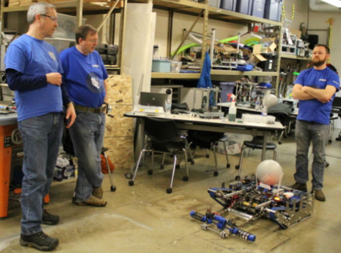 Robotics+team+mentors+oversee+the++testing+of+their+robot%2C+Smokey+IX.+The+robotics+team+will+be+demonstrating+their+robot+at+the+science+fair+on+Saturday.