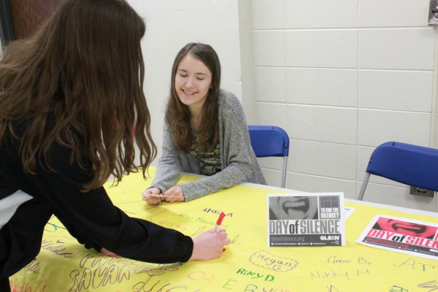 Students sign the Day of Silence poster in support of the LGBT awareness campaign. The Day of Silence takes place April 15 and the Night of Noise dance follows that night.