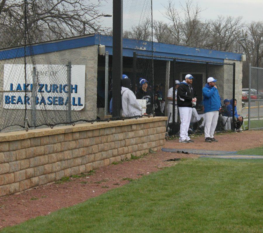 Tom Reagan, interim head baseball coach, in the dugout during the varsity game on April 13.  
The Bears won against Zion-Benton 6-0.