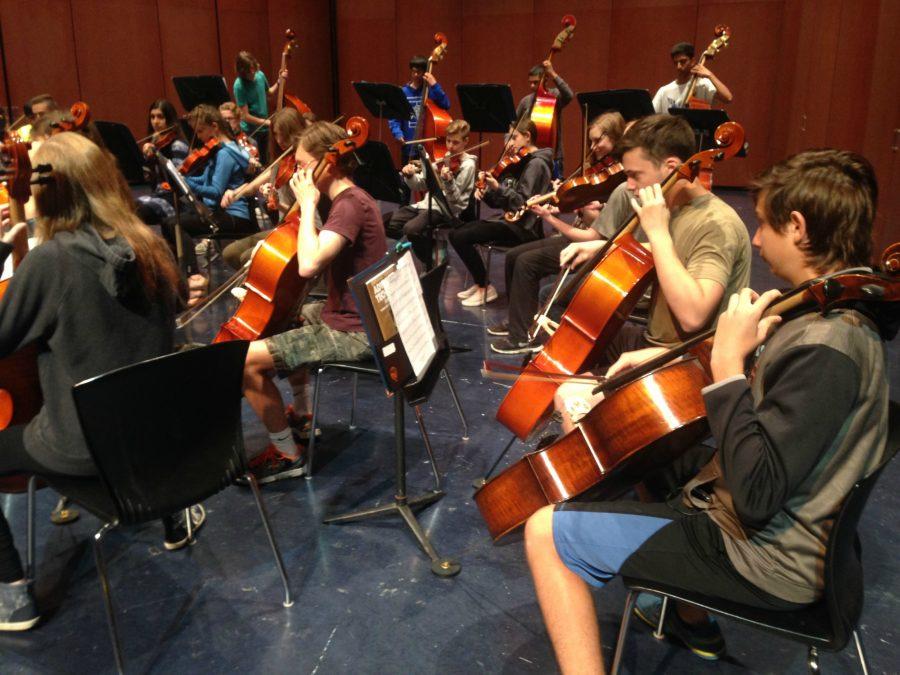 Orchestra members from first period  rehearse in the PAC. Students will take a break from practice, but still gain a lesson by watching the Chicago symphony rehearse on May 18