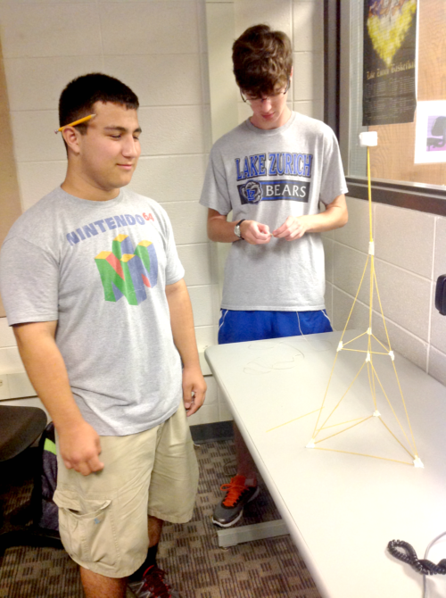 Andy+Gatza%2C+freshman%2C+and+John+Burke%2C+senior%2C+finish+a+tower+their+group+made+out+of+spaghetti%2C+tape%2C+and+a+marshmallow.+This+exercise+on+the+first+day+of+class+was+designed+to+promote+problem+solving+and+creativity%2C+according+to+Ann+Heltzel%2C+computer+science+teacher.