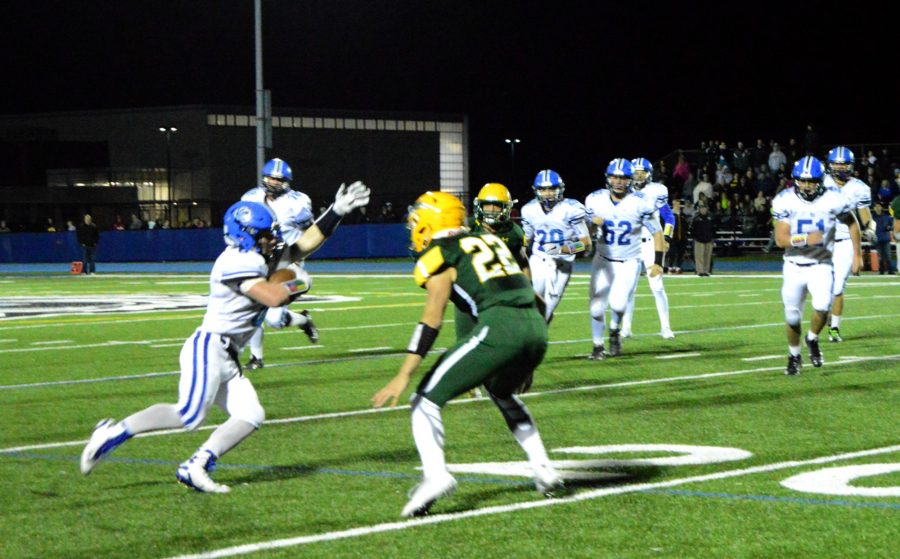 Joey Stutzman, junior linebacker, tries to outrun The Patriots defense.