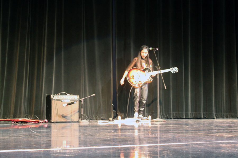 Francesca Castro, senior performer, plays her guitar in the 2015 talent show. She has performed every year of her high school career.