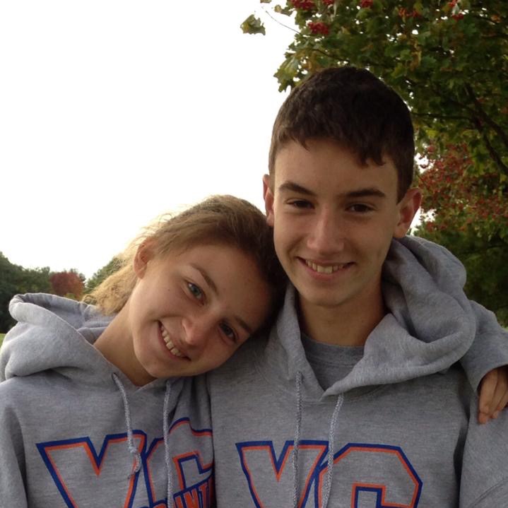 Patrick and Emily Burns stand together in their cross country sweatshirts at the IESA State Championship in 2013. 