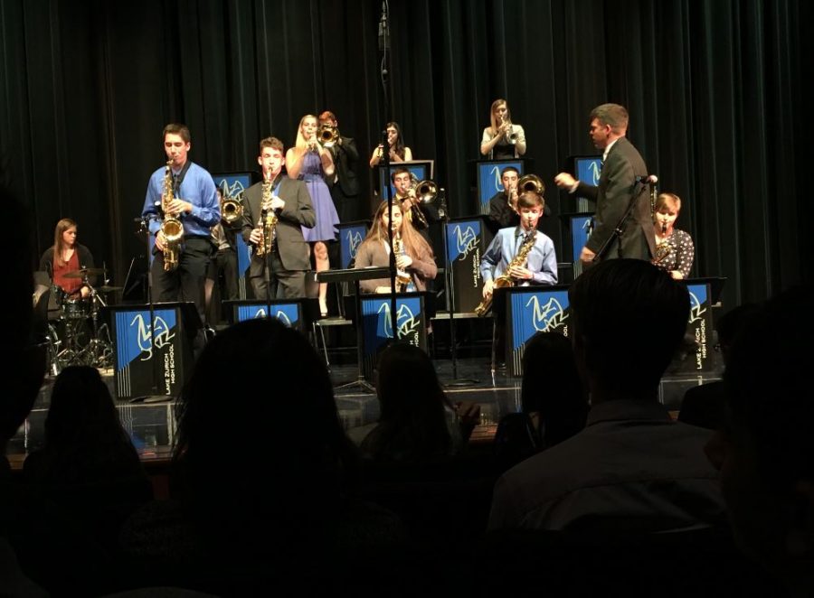 Tyler Sarvady and Will Madsen, juniors, stand up for a solo during the Jazz Band Concert. Both musicians are part of the Jazz Ensemble and participate in improvised solos throughout the year. 
