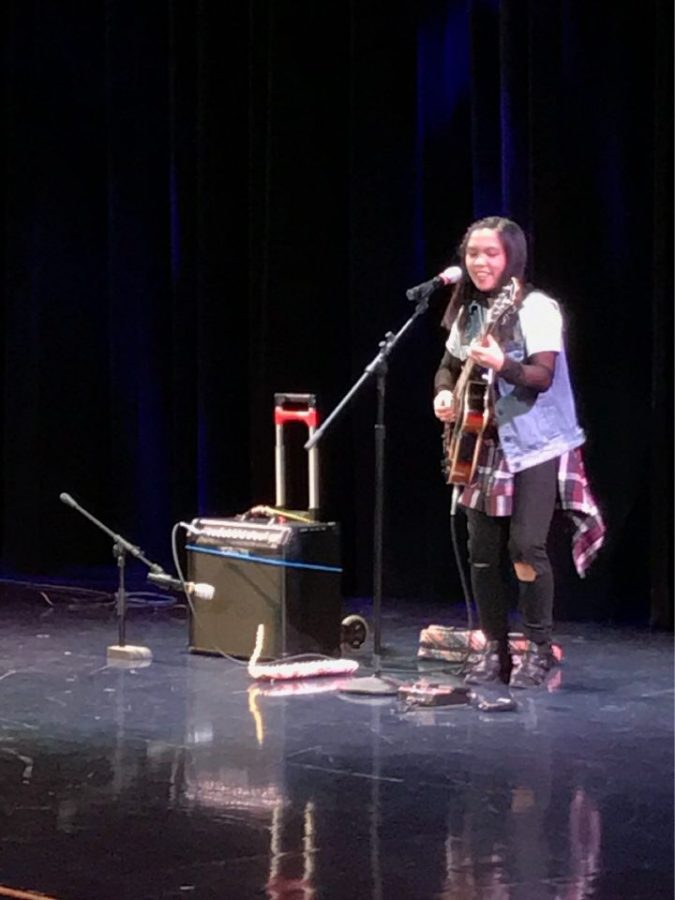 Francesca Castro, senior, performing at the talent show. Castro won first place by playing guitar, melodica, and singing Stevie Wonders Isnt She Lovely.