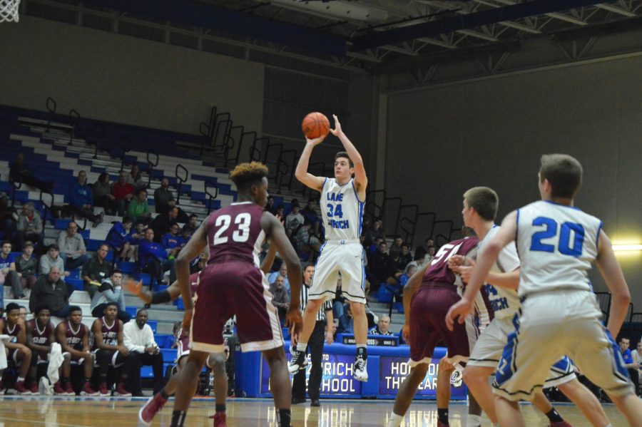 Ryan Kutsor, junior shooting guard, hangs in there during a mid-lane jump shot. 