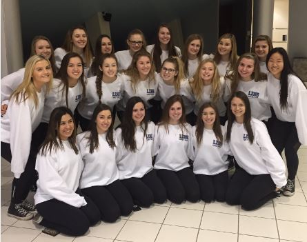 The varsity poms team poses for a picture after their State march on Thursday. The team finished 11th overall at IHSA State Finals. Photo by Anna Lubera.
