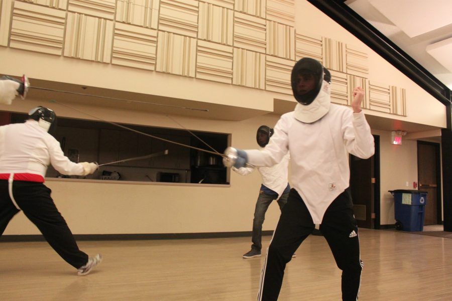 Christian Schumacher, senior fencer, fights his opponent during a class at the Barrington Fencing Club.