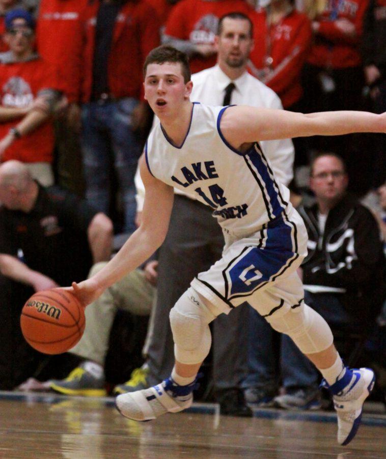 Michael Bens, senior guard, dribbles around the perimeter while looking for a pass.