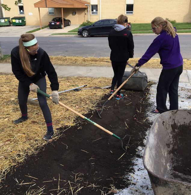 Students volunteering at Habitat for Humanity build days.