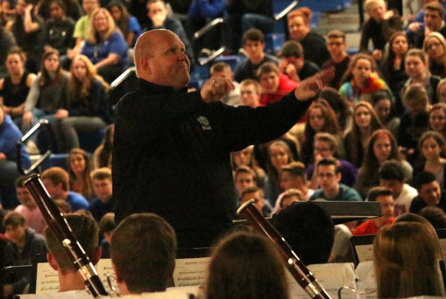 Kent Nightlinger, principal, directs the wind ensemble in his final spring assembly.