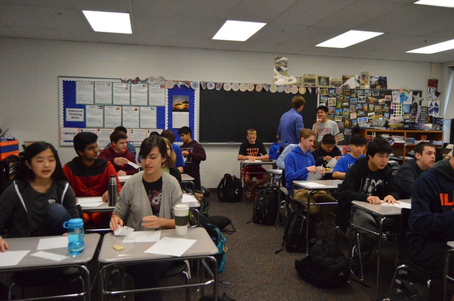 Students in the new international club participate in a South Korean paper folding activity. 