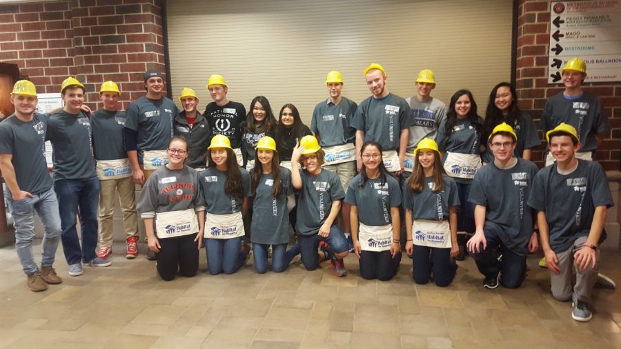 Habitat for Humanity volunteers stand together during a fundraiser for the organization in Arlington Heights. 