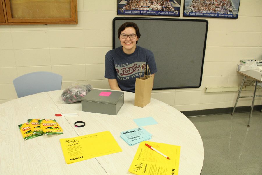 Riley Danca, junior, works at the  Day of Silence informational table to accept pledges of silence.