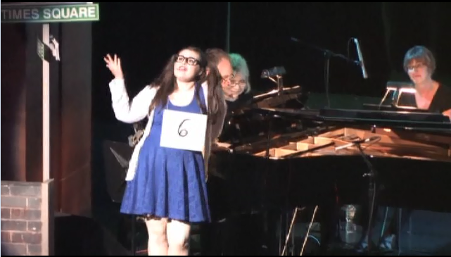 Caitlyn Bertrand, senior, performs a solo part as Chirs Misik, music tutor, and Nick Juknelis, choir teacher, plays piano for the 2014 Kaleidoscope showcase. This year is different than others with the theme, Another Day of Song.