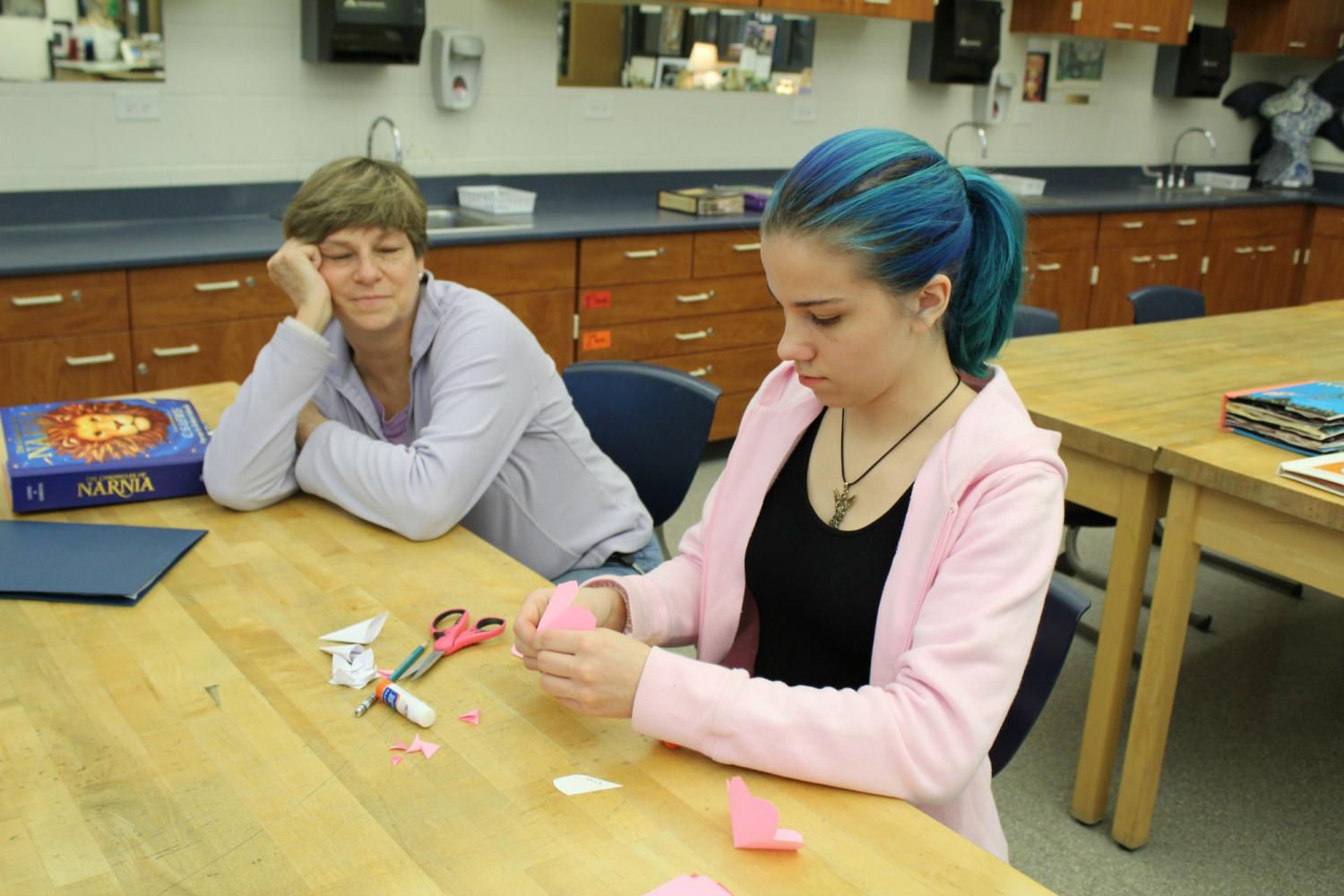 Caitlyn Wenzel, eighth grader at Middle School North, makes a pop-up card with her mother at the District STEAM Night. The pop-up cards were just one of many activities meant to get kids excited about STEAM.