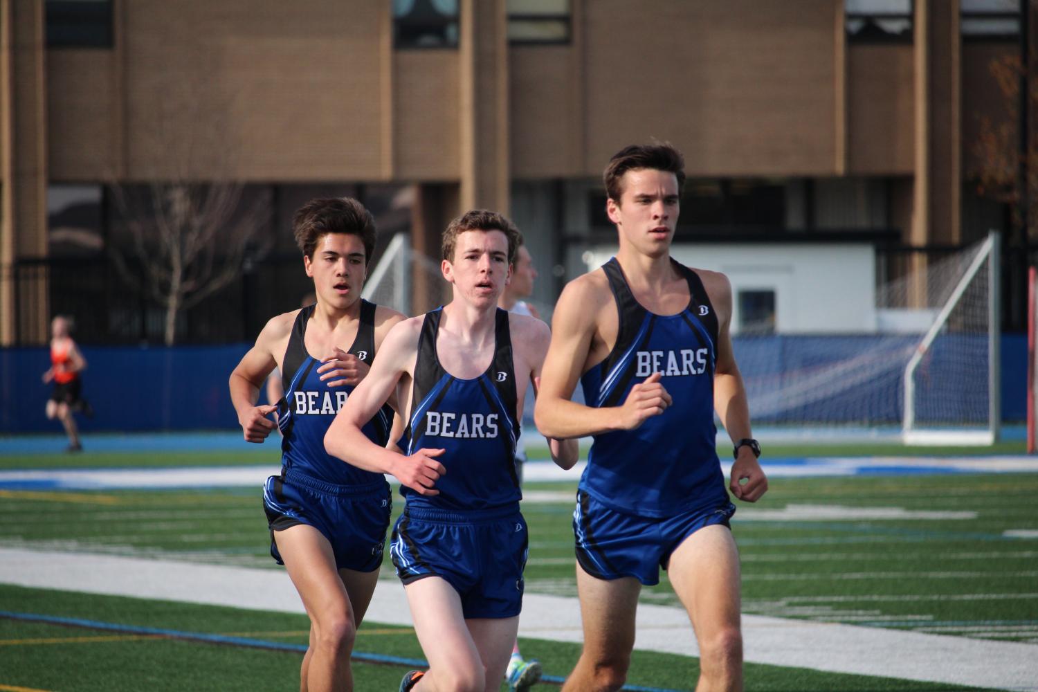 Runners (from right to left) Brian Grifftih, Sean Finn, and Drake Heisterkamp race against their competitors