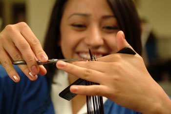 A student from the Cosmetology class practices cutting hair. Alexia Maldonado, senior in the cosmetology program, says it takes 1500 hours to fulfill a cosmetology liscense, a task the program helps students complete.