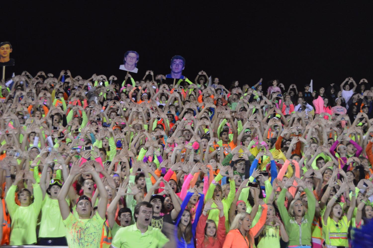 The Student Section cheers during a kickoff against Warren. This year's Student Section had one leader and several helpers, but future Sections will have approximately ten spread out over a greater number of sports and activities.