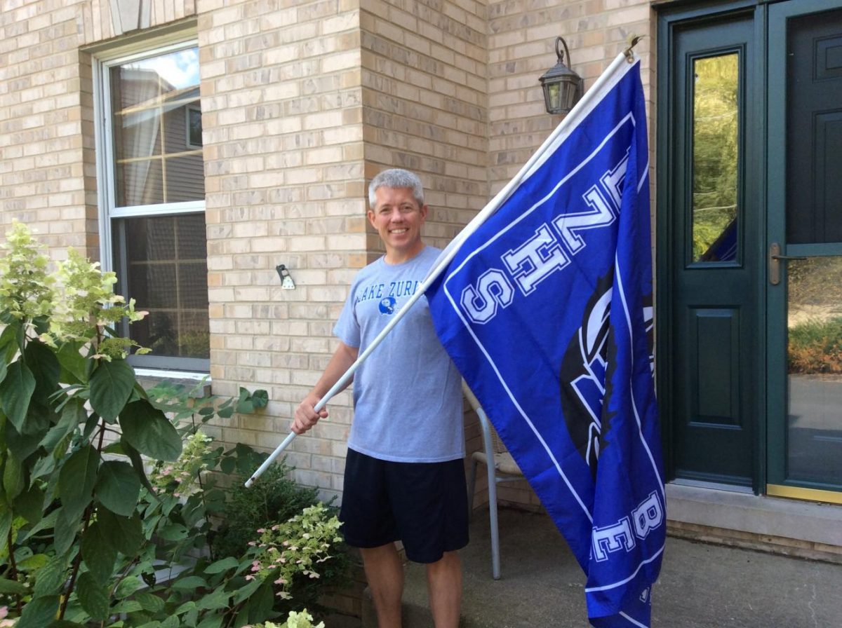 Doug Miller, QB Club vice president, displays  his Lake Zurich Bears flag outside his house.