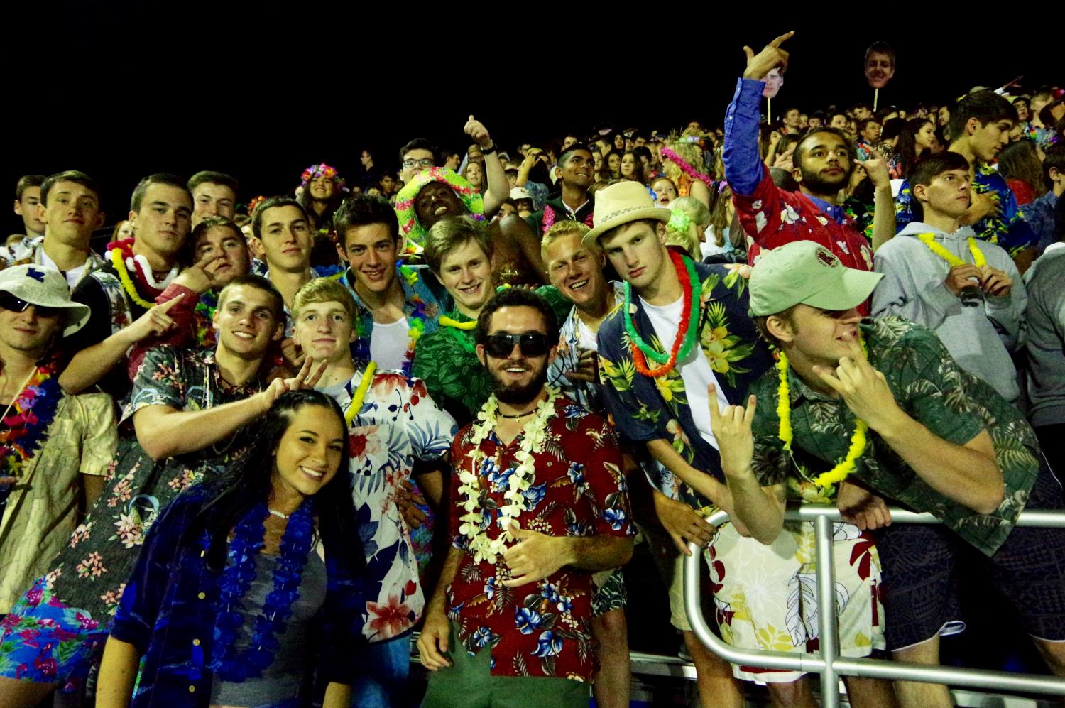 Student Section leaders Jordan Dickson, Will Ergastolo, and Ronan Kennedy join students in the stands to support the Bears at their football game.