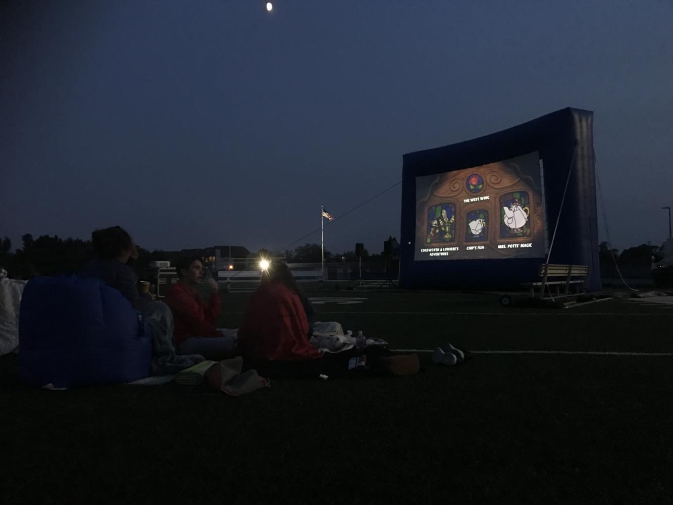 Onlookers watch as Monsters Inc plays on the big screen. Student Council held a showing of the movie on the football field for the annual movie night.