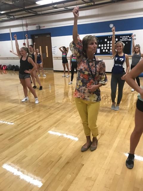 Teri Johlie, poms coach,  instructs her team on the next routine at practice. 