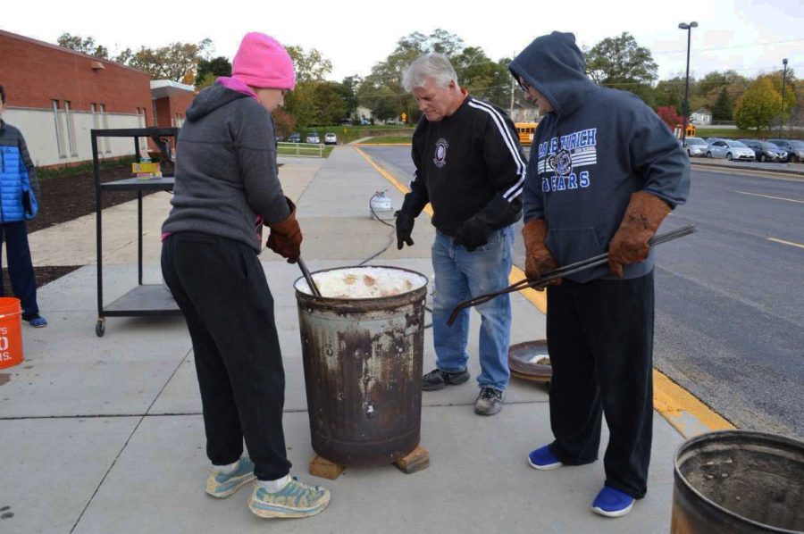 LZ students work with the Raku firing process.  The students work with the tin can and tools to create the metallic and brightly colored outcome of the pottery.  