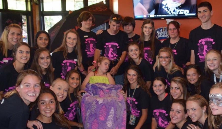 LZHS cheerleaders surround Alyssa during the fundraiser at BBQ Productions, after she was just announced as an honorary cheerleader. 