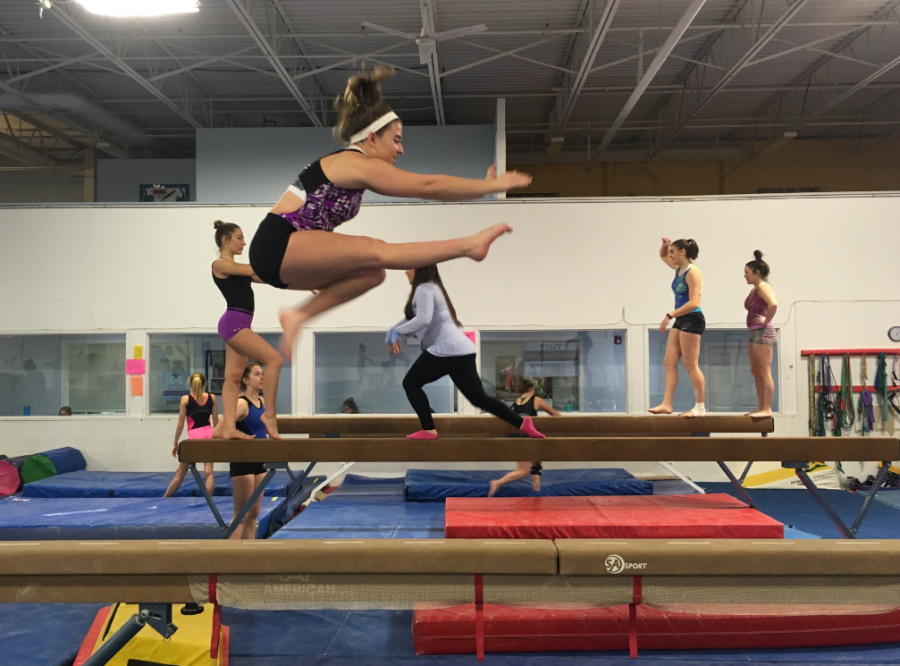Krista Wohler, sophomore gymnast, practices a wolf jump on the beam at United States Gymnastics Training Center. The gymnastics team began practices at USGTC this past week. 